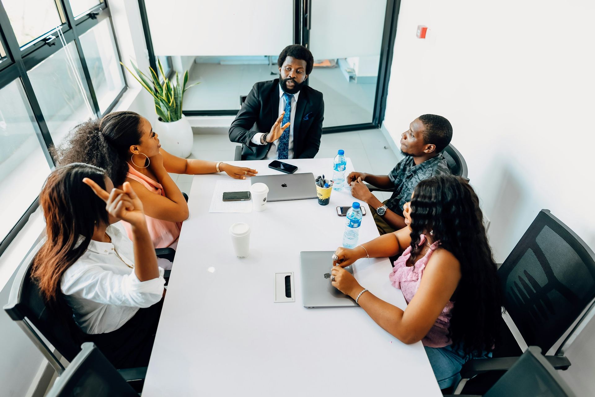 Business professionals discussing strategy around a boardroom table