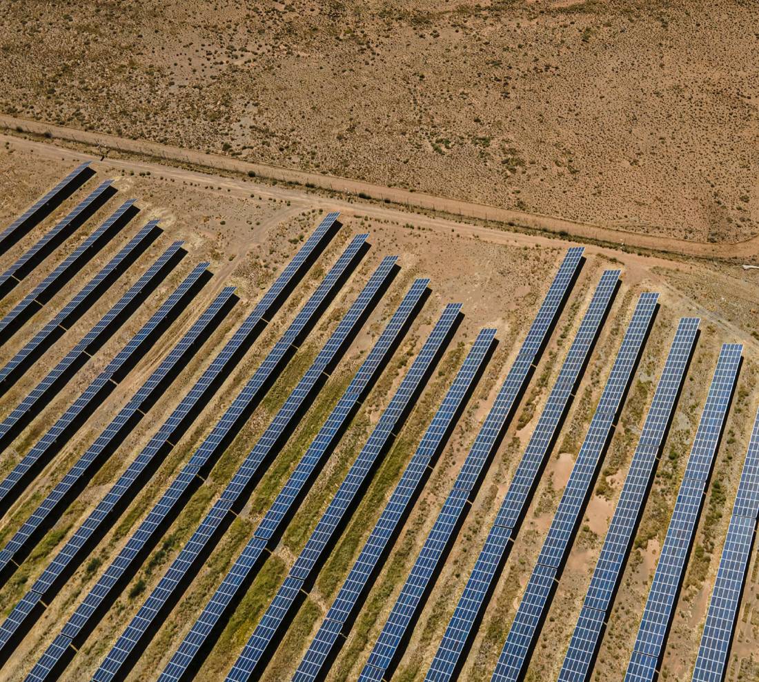 Aerial view of a solar farm in a semi-desert landscape